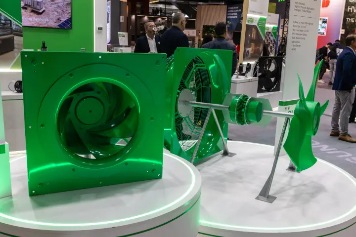 Sunon green plug fan and exploded axial fan assembly on lit plinths at MCE 2026
