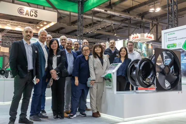 Sunon guests beside black EC fans and a touchscreen info kiosk at MCE 2026
