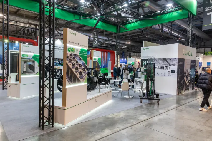 Sunon stand under a green truss frame with a large ceiling fan at MCE 2026
