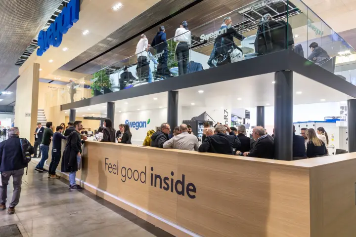 Swegon double-deck stand with "Feel good inside" wooden bar counter at MCE 2026