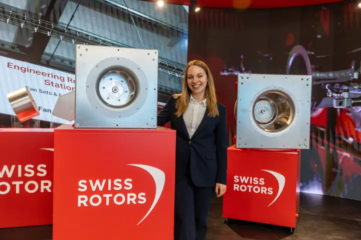 Swiss Rotors plug fans on branded red plinths with LED backdrop
