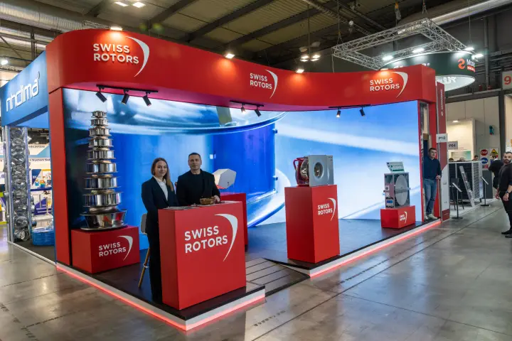 Swiss Rotors stand with staff at counter and heat recovery wheel exhibit at MCE 2026