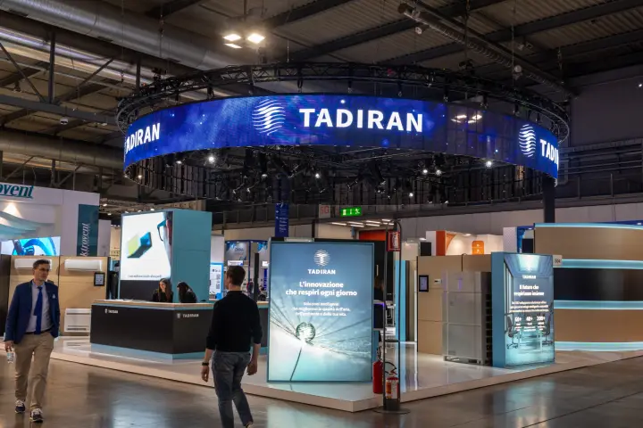 Tadiran stand under a circular LED ring with lightbox panels and reception desk