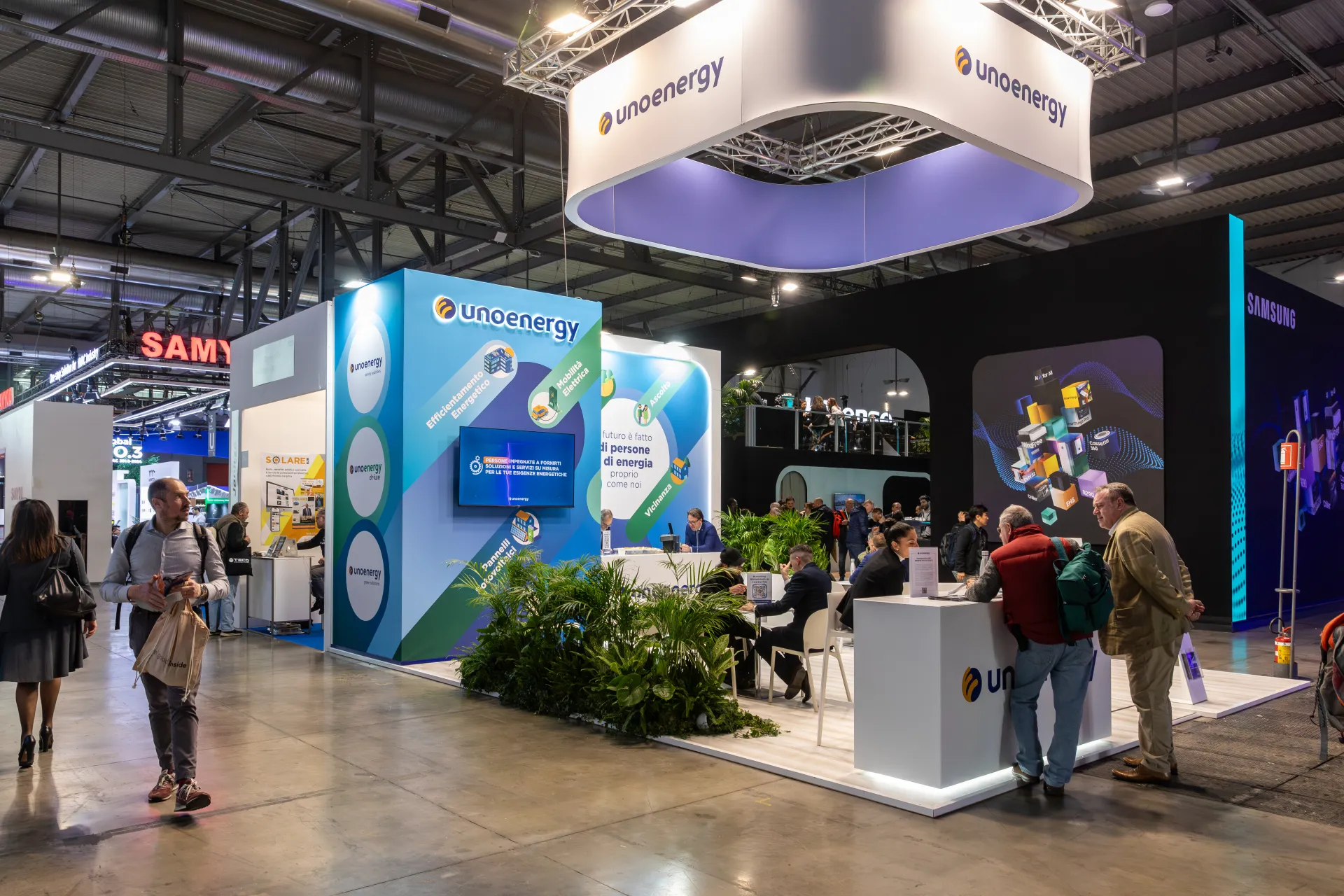 Unoenergy stand with a suspended logo ring and energy services graphics at MCE 2026