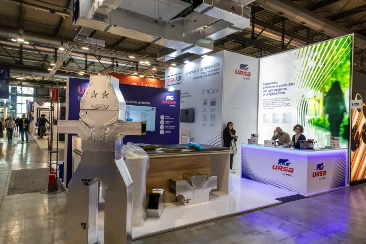 URSA by Etex stand with duct-panel robot figure and backlit reception counter