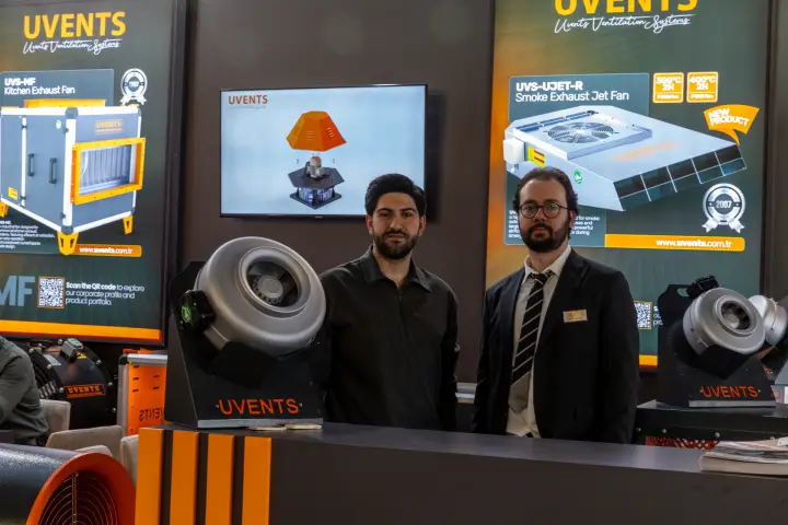 Uvents staff behind counter with UVS-MF and UVS-UJET-R posters