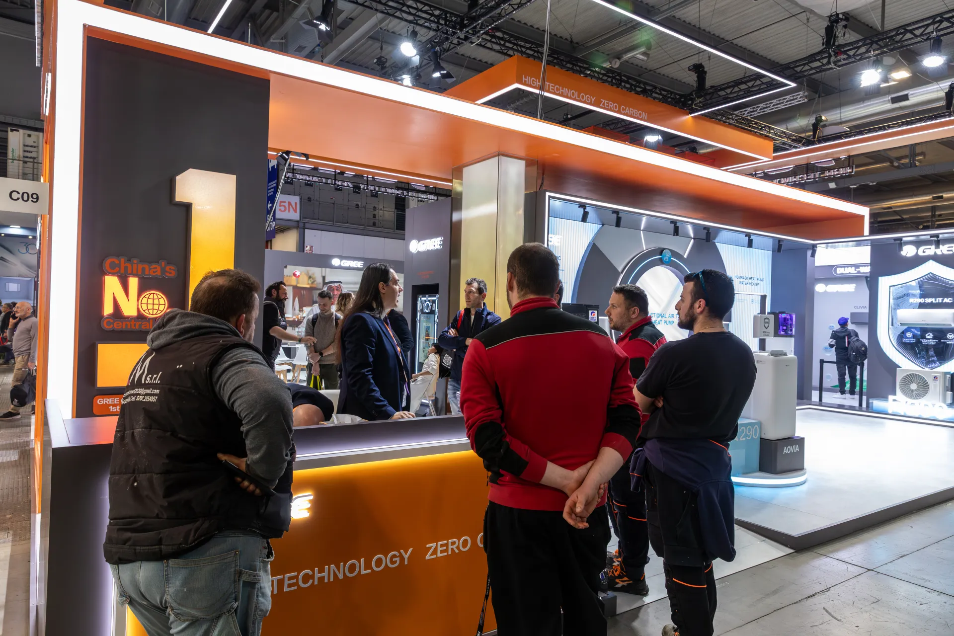 Visitors gather at the orange Gree reception counter under the zero-carbon canopy at MCE 2026