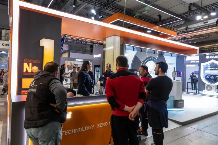 Visitors gather at the orange Gree reception counter under the zero-carbon canopy