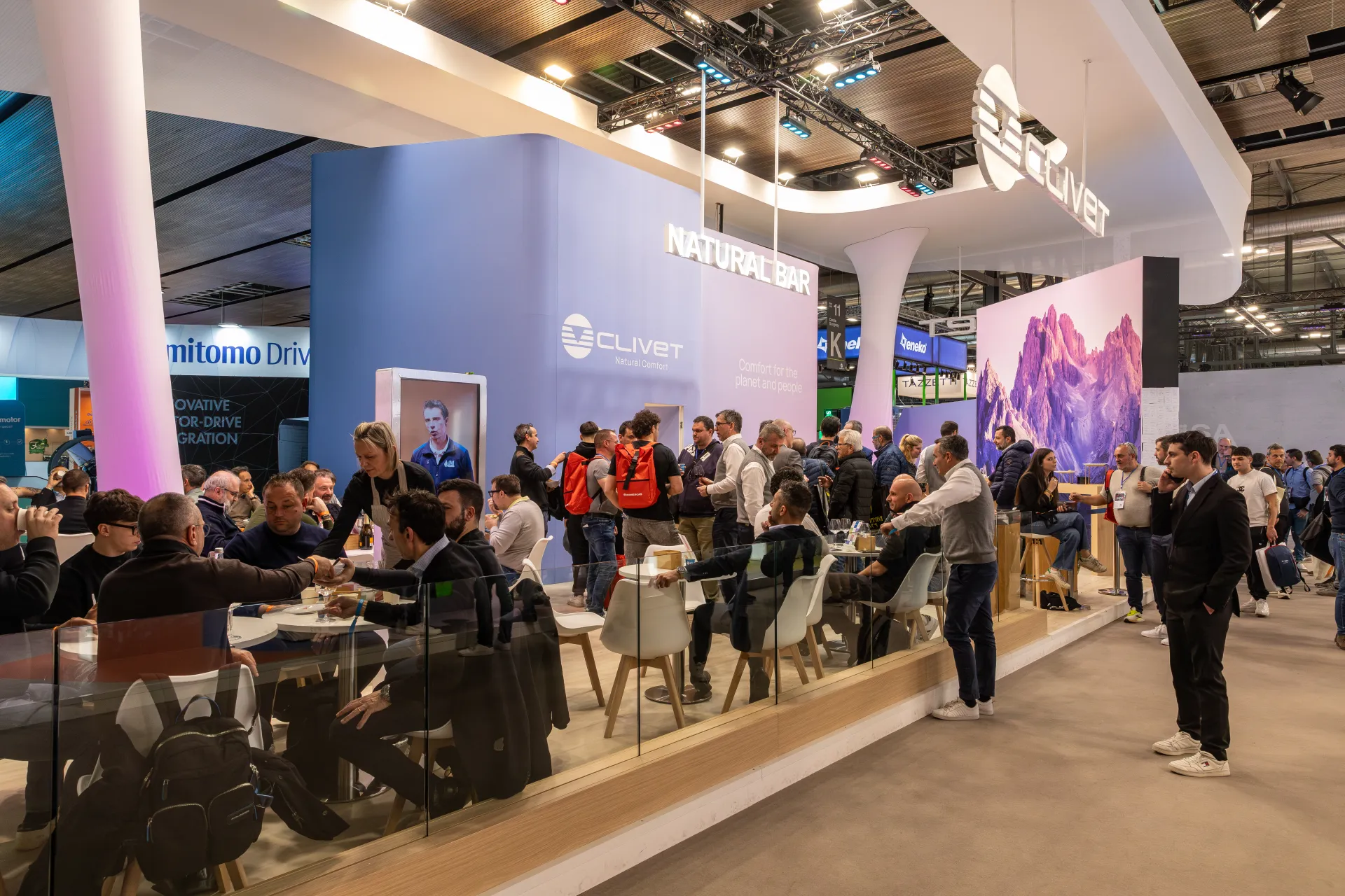 Wide aisle view of the busy Clivet Natural Bar and mountain backdrop at MCE 2026