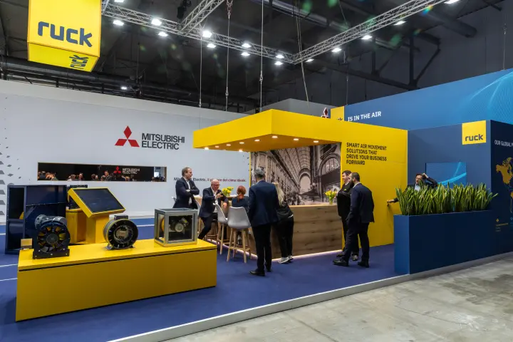 Wide view of the Ruck stand with hanging cube and fan podium at MCE 2026