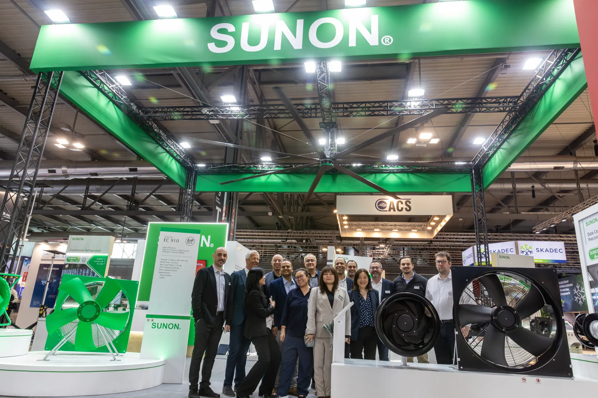 Wide view of Sunon truss stand with group under the large ceiling fan at MCE 2026