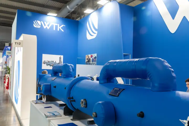 WTK heat exchanger in front of the logo wall at stand T12 at MCE 2026