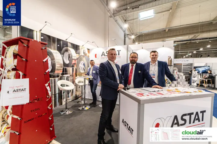 Astat team behind the branded counter beside a red tape display tower at Warsaw HVAC Expo 2024