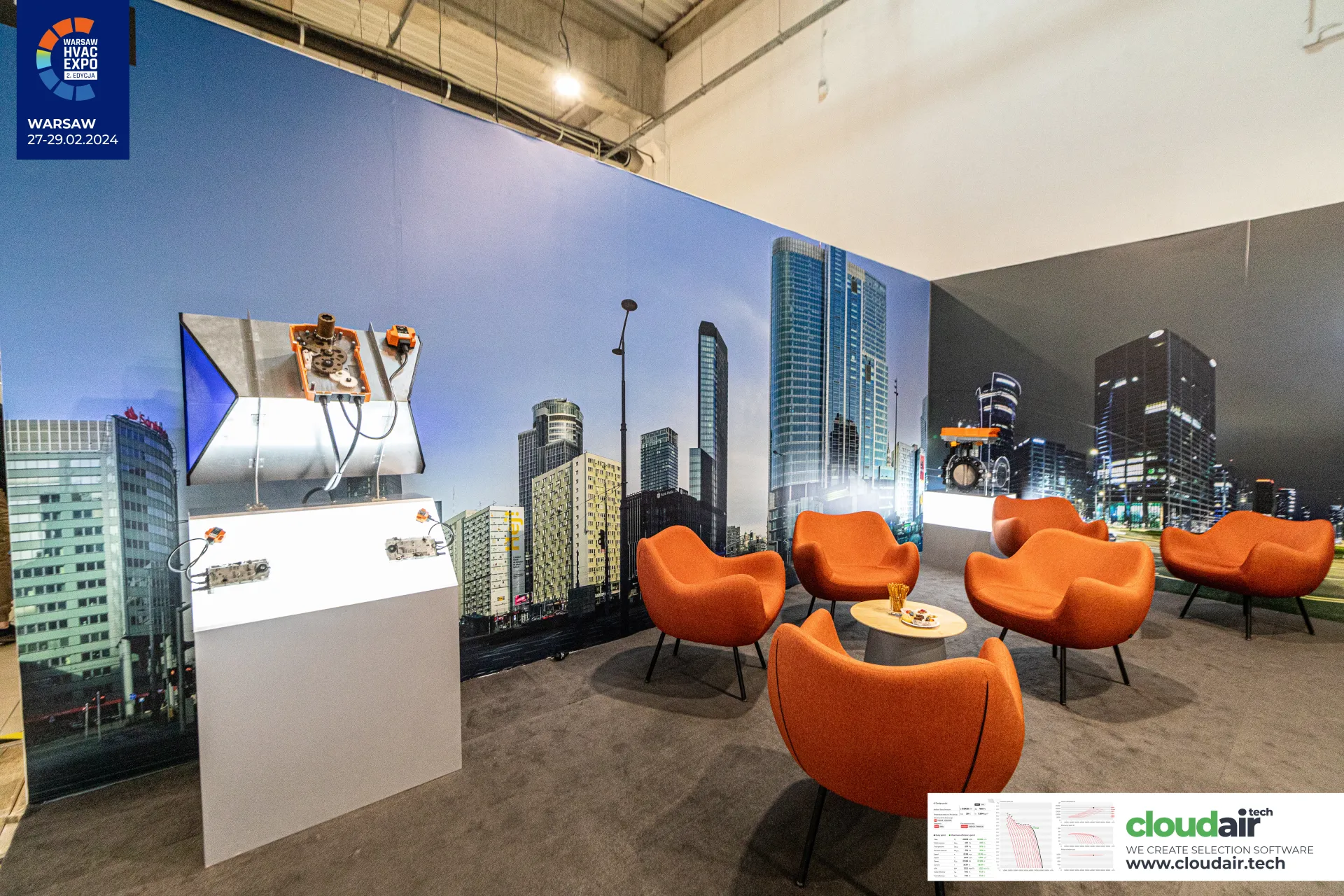 Belimo lounge with orange armchairs and an opened actuator on a duct section at Warsaw HVAC Expo 2024