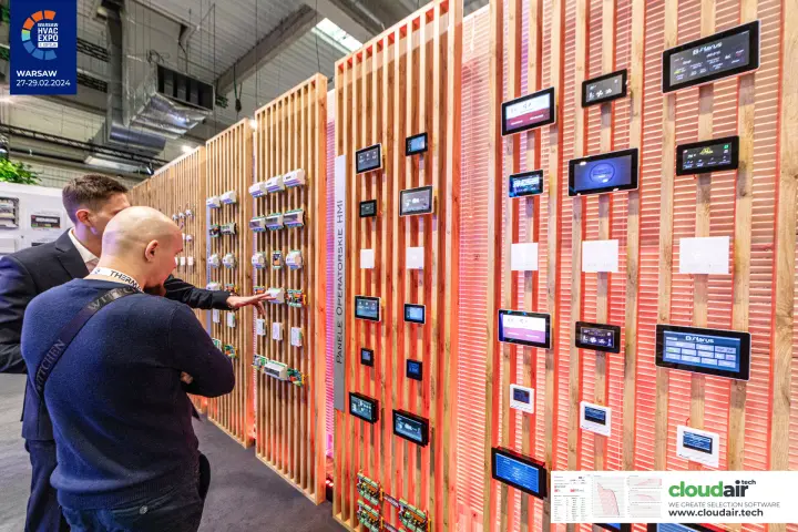 Close-up of HMI touch panels and controllers on red-lit timber slats at Warsaw HVAC Expo 2024