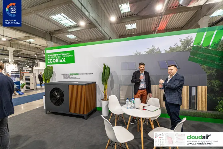 ECOBloX heat pump with wood-slat casing beside a meeting table at Warsaw HVAC Expo 2024
