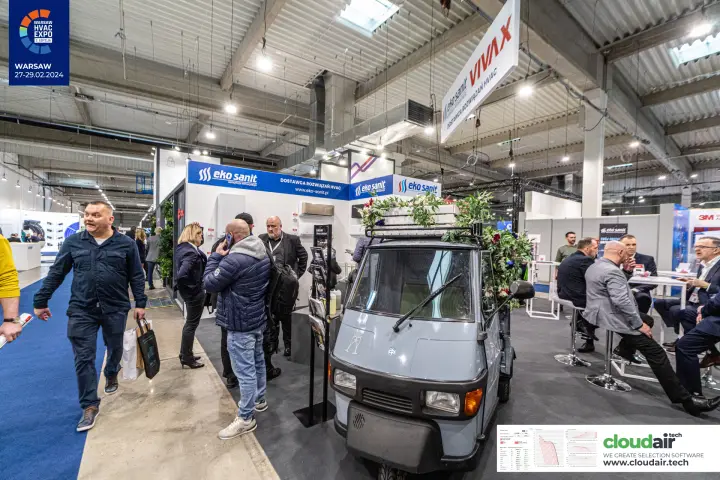 Eko Sanit stand with Vivax sign and flower-decked three-wheeler