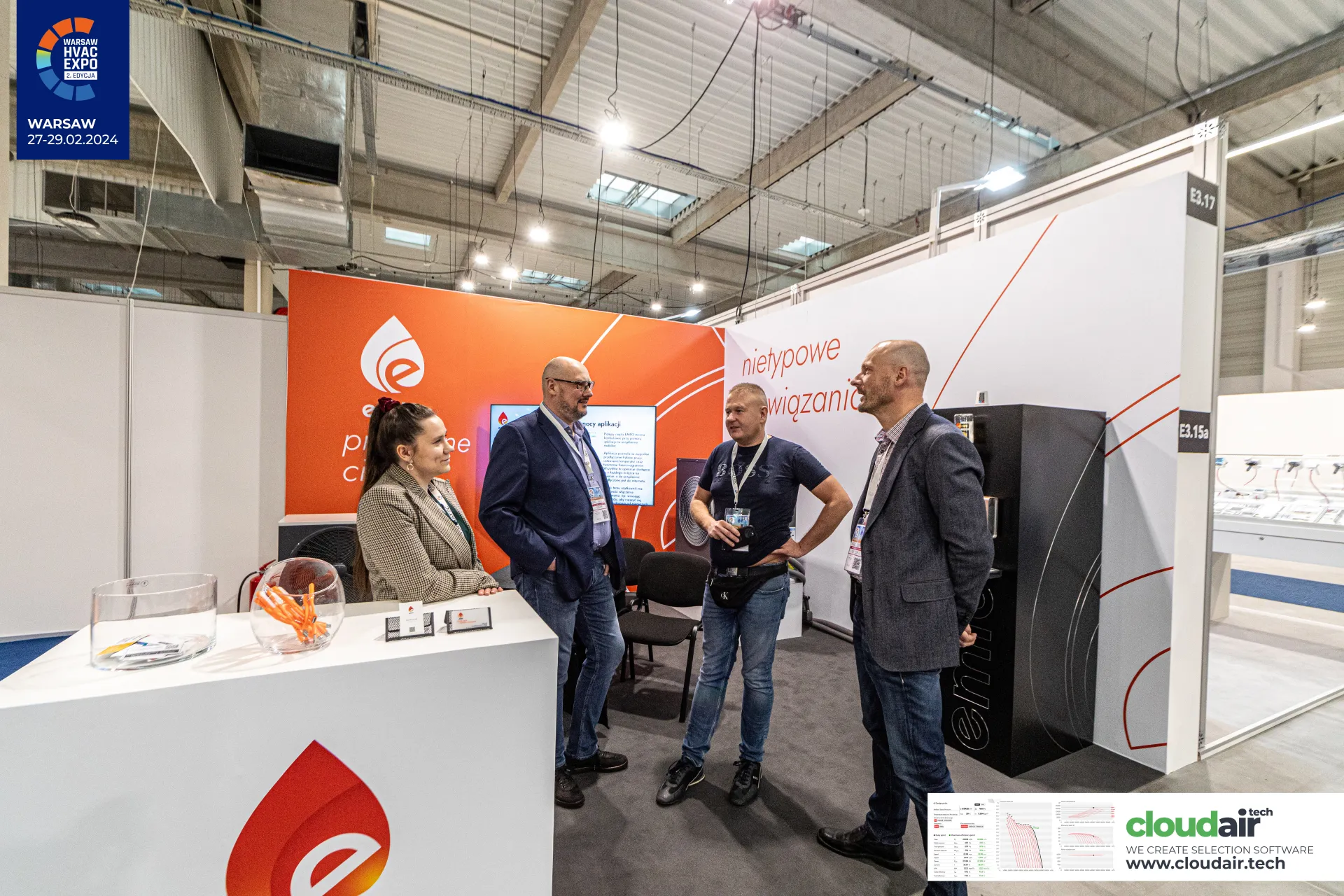 Emto stand E3.17 with staff and visitors talking by the counter at Warsaw HVAC Expo 2024