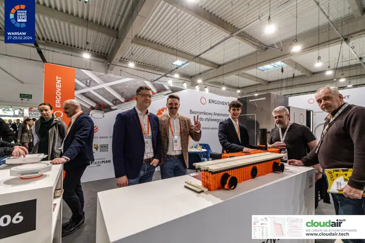 Ergovent team behind the plenum box display with award logos on the wall
