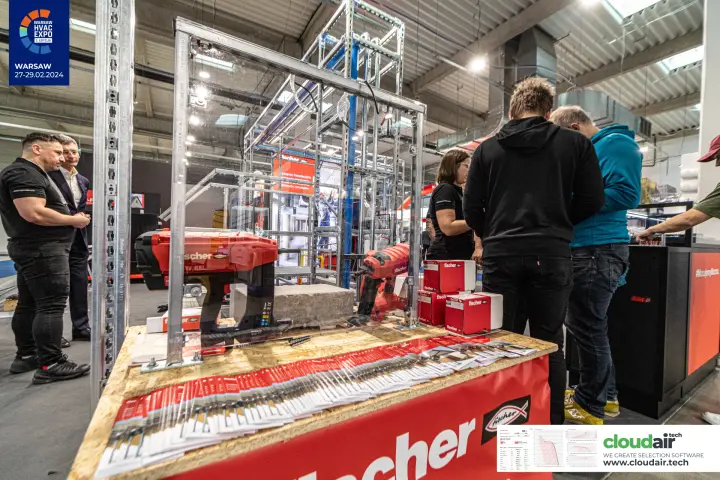 Fischer cordless fixing tools and fastener boxes on a demo counter at Warsaw HVAC Expo 2024