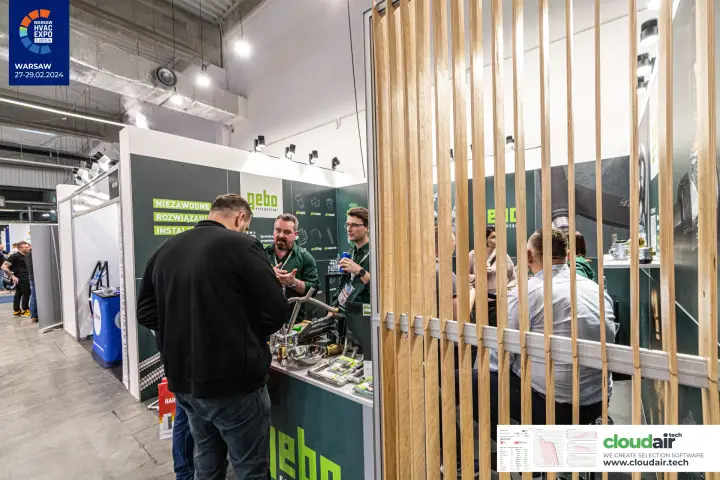 Gebo counter with flexible hoses behind a wooden slat partition at Warsaw HVAC Expo 2024