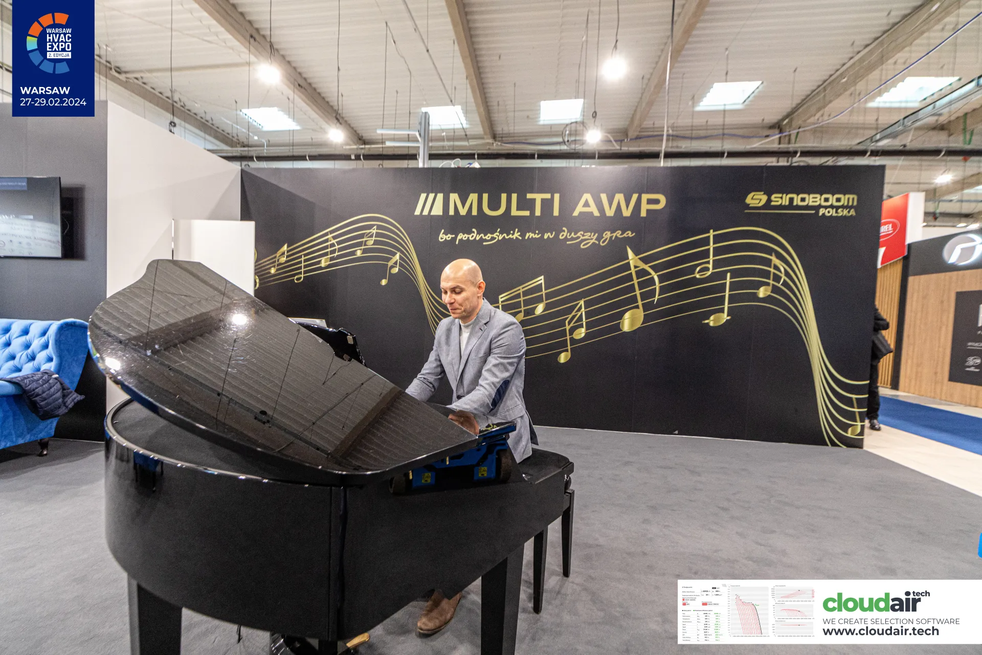 Grand piano in front of the Multi AWP and Sinoboom Polska music-themed wall at Warsaw HVAC Expo 2024