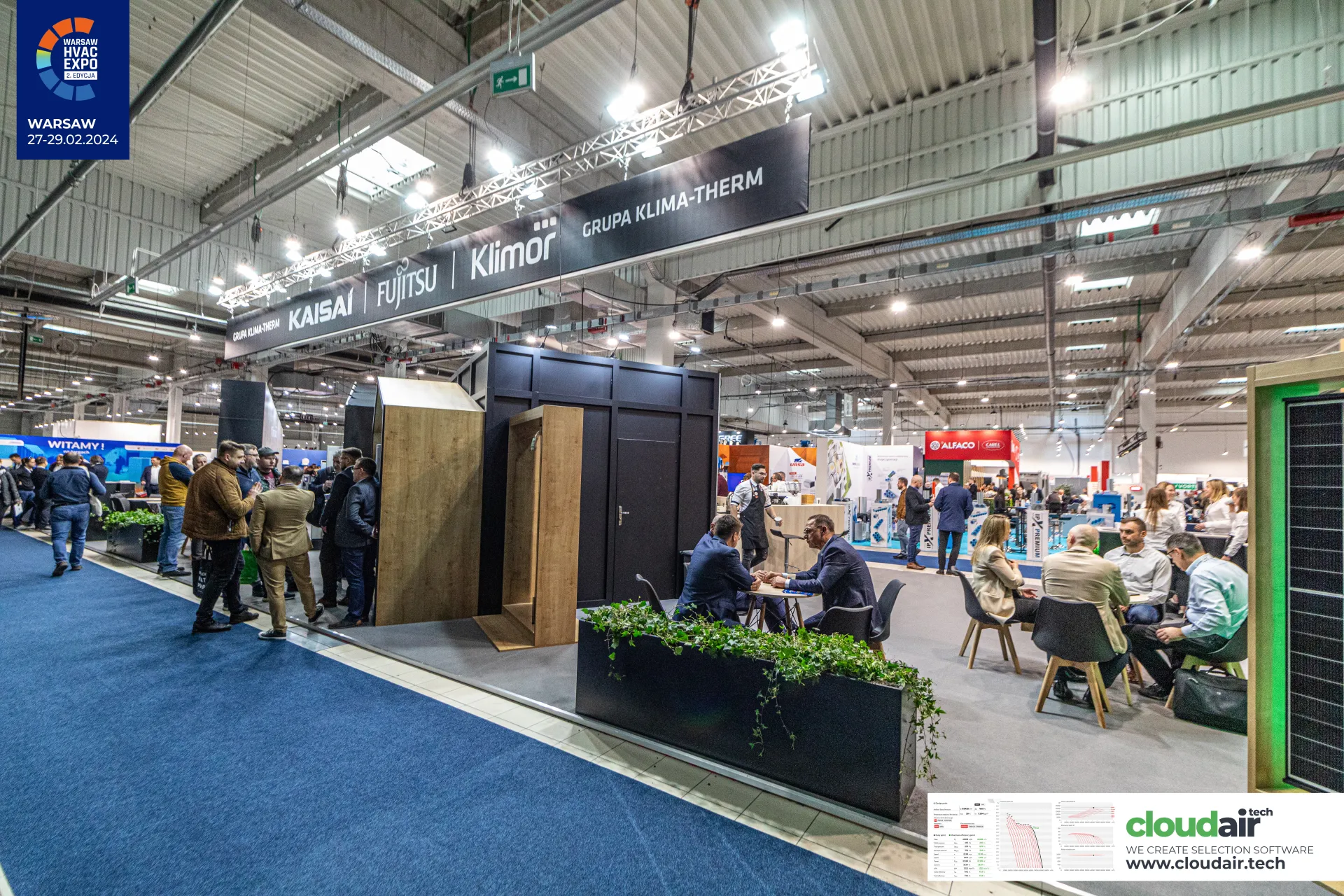 Grupa Klima-Therm stand from the aisle with wooden house frames and lounge at Warsaw HVAC Expo 2024
