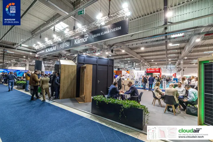 Grupa Klima-Therm stand from the aisle with wooden house frames and lounge at Warsaw HVAC Expo 2024