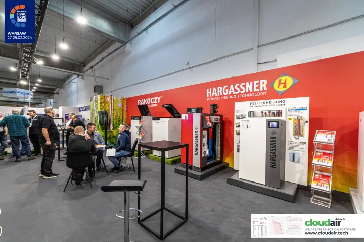Hargassner biomass boilers with an opened unit, beside the Rakoczy display at Warsaw HVAC Expo 2024
