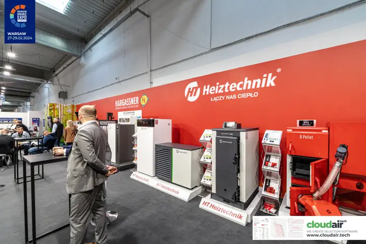 Heiztechnik boilers, heat pump and Q Pellet unit in front of the red brand wall at Warsaw HVAC Expo 2024