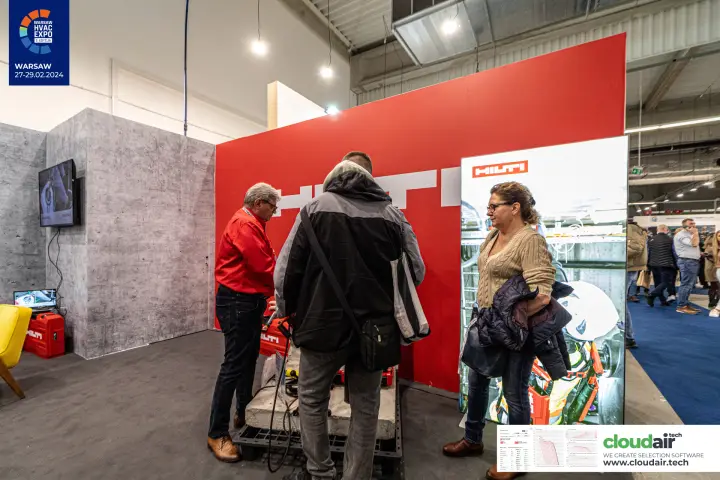 Hilti staff demonstrating a tool on a concrete test block at Warsaw HVAC Expo 2024