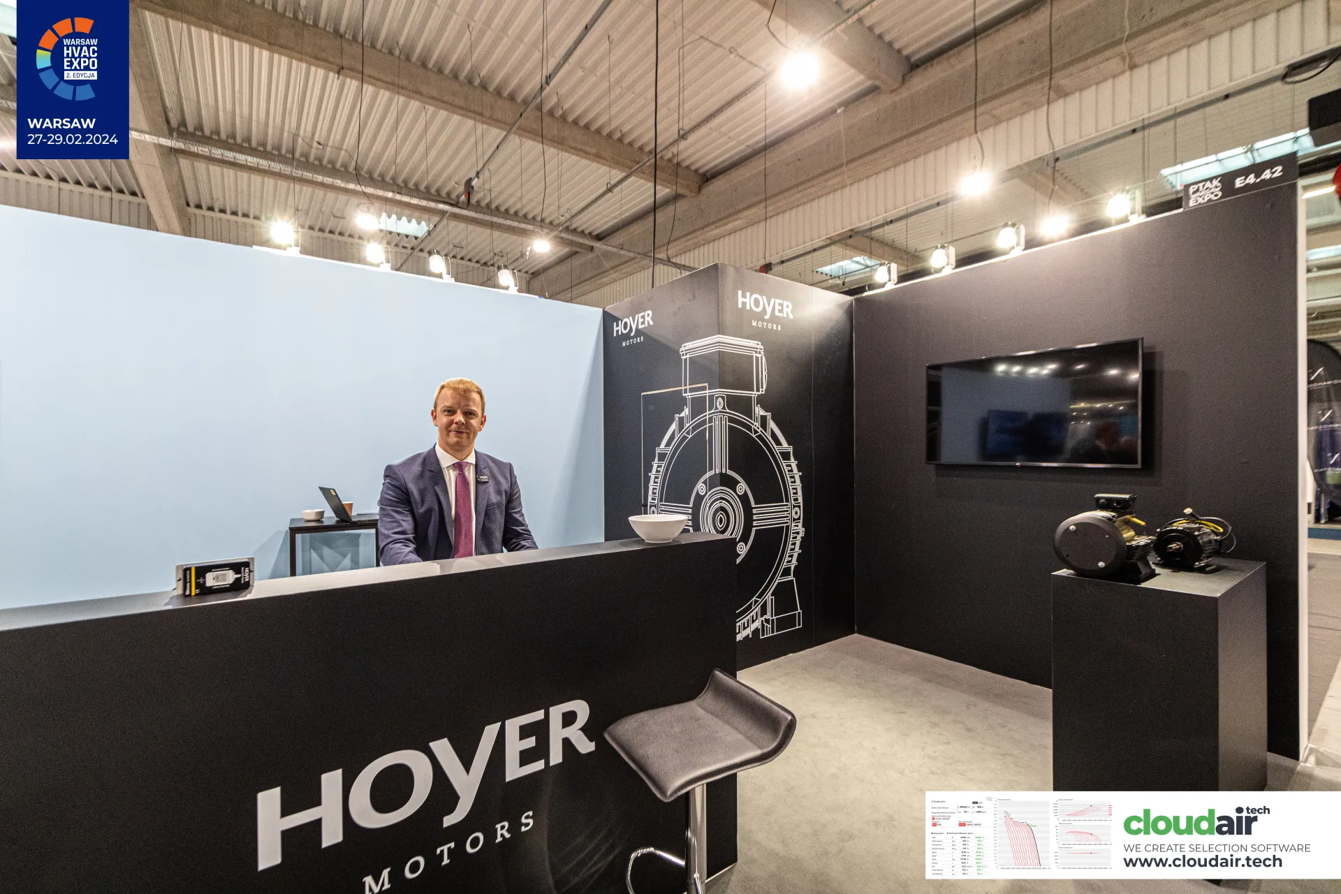 Hoyer Motors reception counter with motor line drawing behind at Warsaw HVAC Expo 2024
