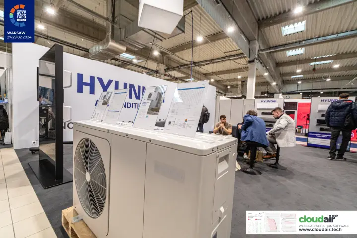 Hyundai outdoor heat pump unit topped with product data sheets at Warsaw HVAC Expo 2024