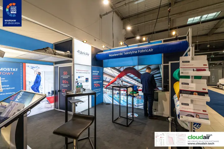 Inside the FabricAir stand with pool photo wall and touchscreen kiosk