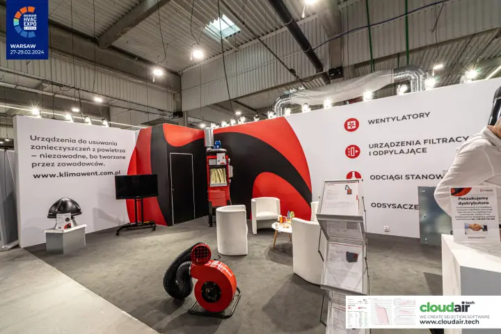 Klimawent stand with red-and-black swirl graphics and white armchairs