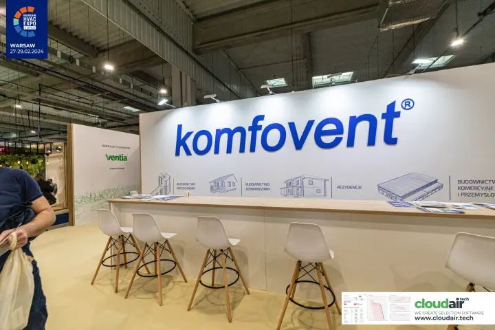 Komfovent logo wall and reception counter with high stools