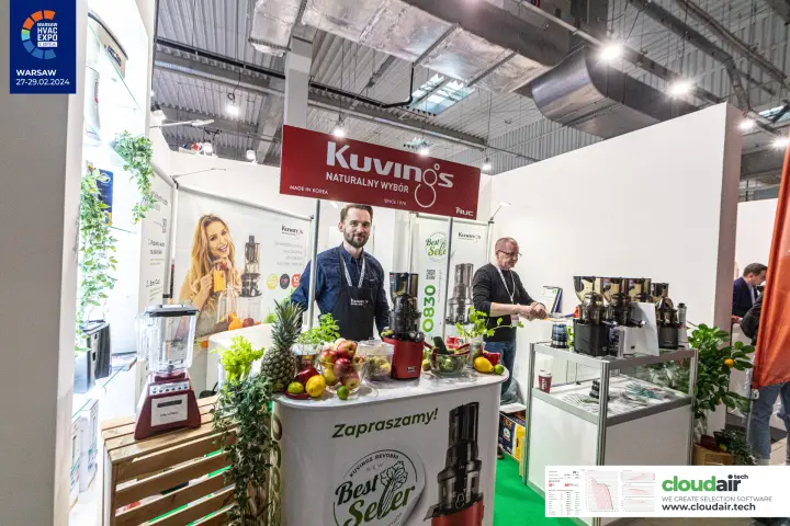 Kuvings stand with slow juicers and fresh fruit on the counter at Warsaw HVAC Expo 2024
