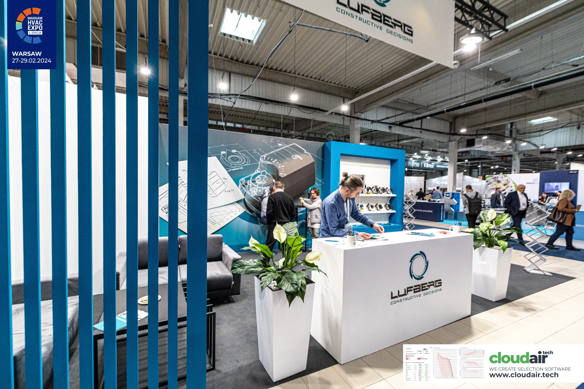 Lufberg stand seen through blue slats, with a suspended brand sign at Warsaw HVAC Expo 2024