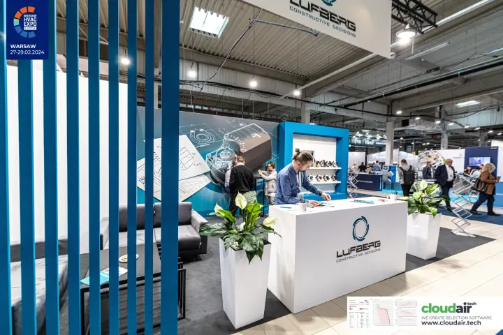 Lufberg stand seen through blue slats, with a suspended brand sign