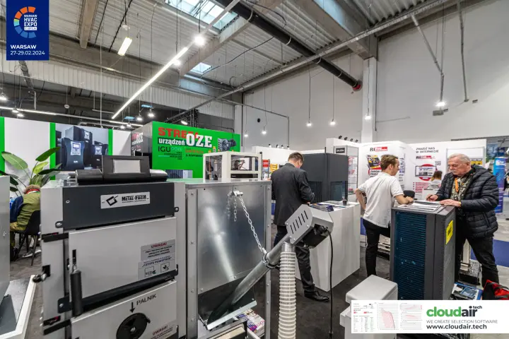 Metal-Fach boiler with pellet hopper and burner warning labels at Warsaw HVAC Expo 2024