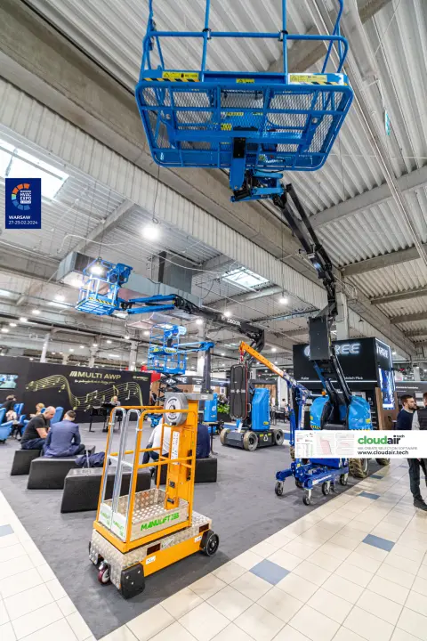 Multi AWP stand with articulating boom lifts raised to the hall ceiling at Warsaw HVAC Expo 2024