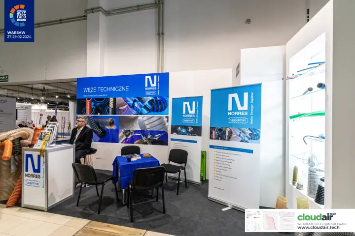 Norres and Baggerman stand with technical hoses on glass shelves at Warsaw HVAC Expo 2024