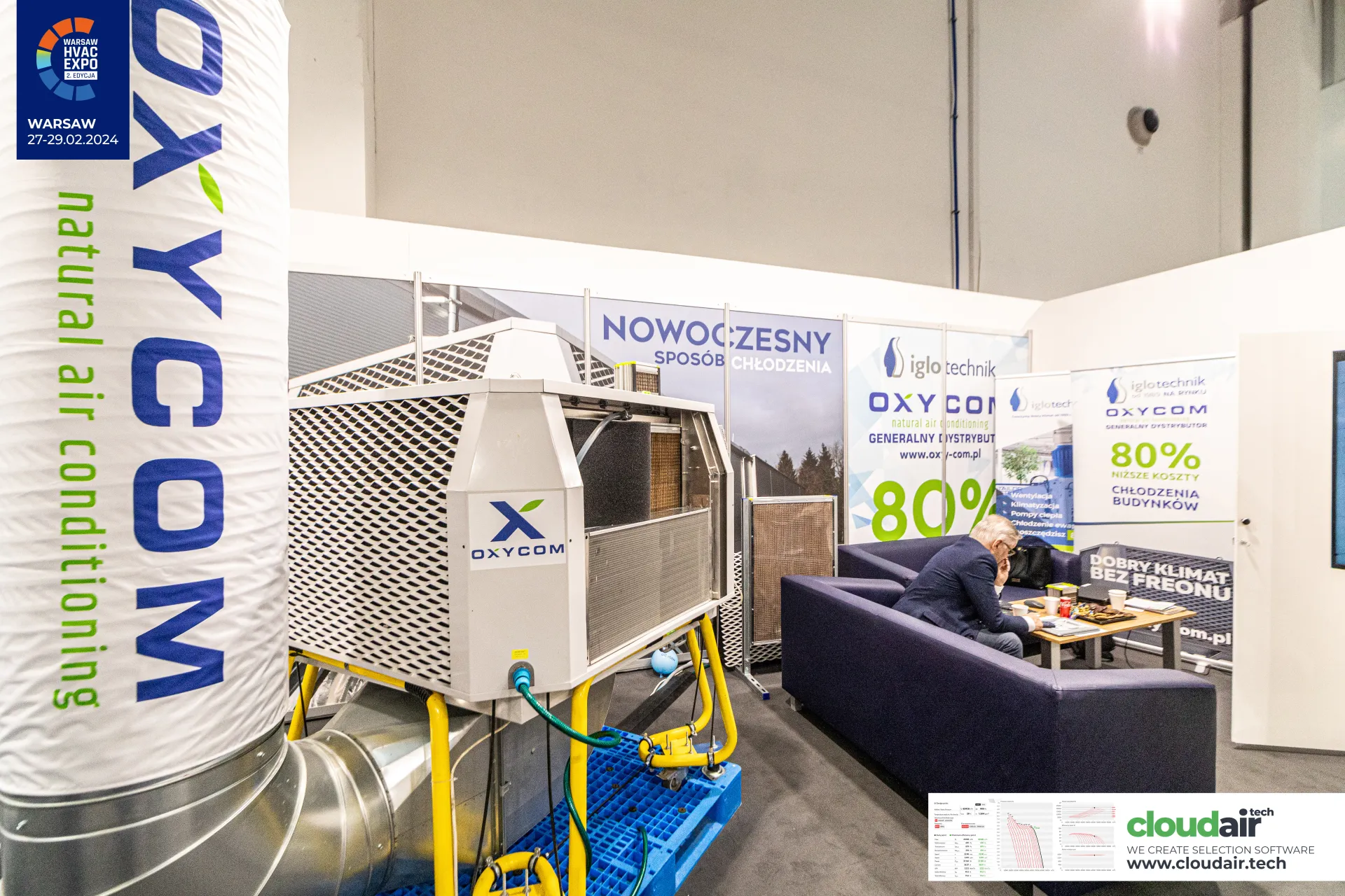 Oxycom cooling unit beside a sofa area with low-cost cooling claims at Warsaw HVAC Expo 2024