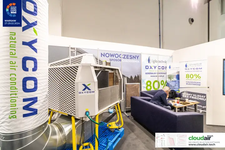 Oxycom cooling unit beside a sofa area with low-cost cooling claims at Warsaw HVAC Expo 2024