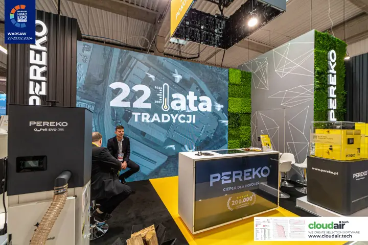 Pereko LED wall marking "22 lata tradycji" behind pellet boilers