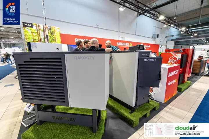 Rakoczy outdoor heat pump and boiler on artificial-grass pallets at the stand edge