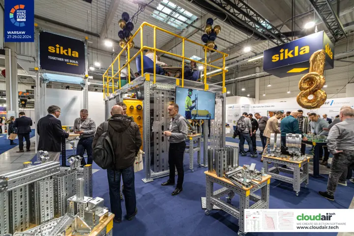 Sikla framing channels and pipe clamps on workbenches at a busy stand at Warsaw HVAC Expo 2024
