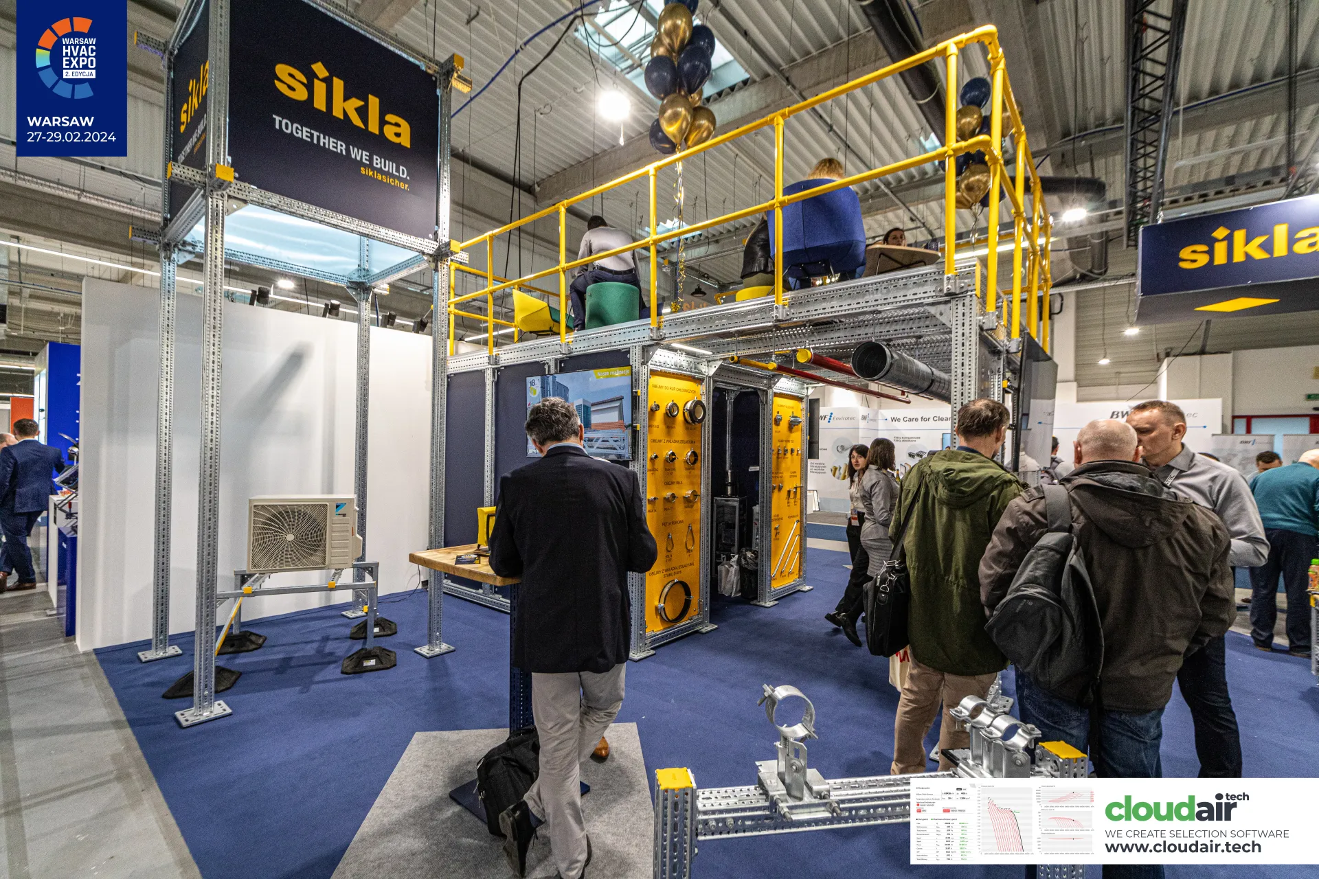 Sikla two-level stand built from galvanised mounting rails and yellow railings at Warsaw HVAC Expo 2024