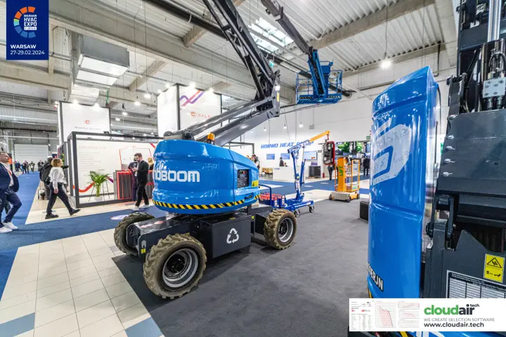 Sinoboom articulated boom lift with raised basket beside a mast lift counterweight at Warsaw HVAC Expo 2024