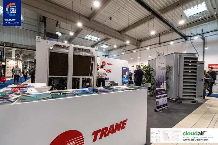 Trane counter with brochures in front of a chiller and AHU on a shared stand at Warsaw HVAC Expo 2024